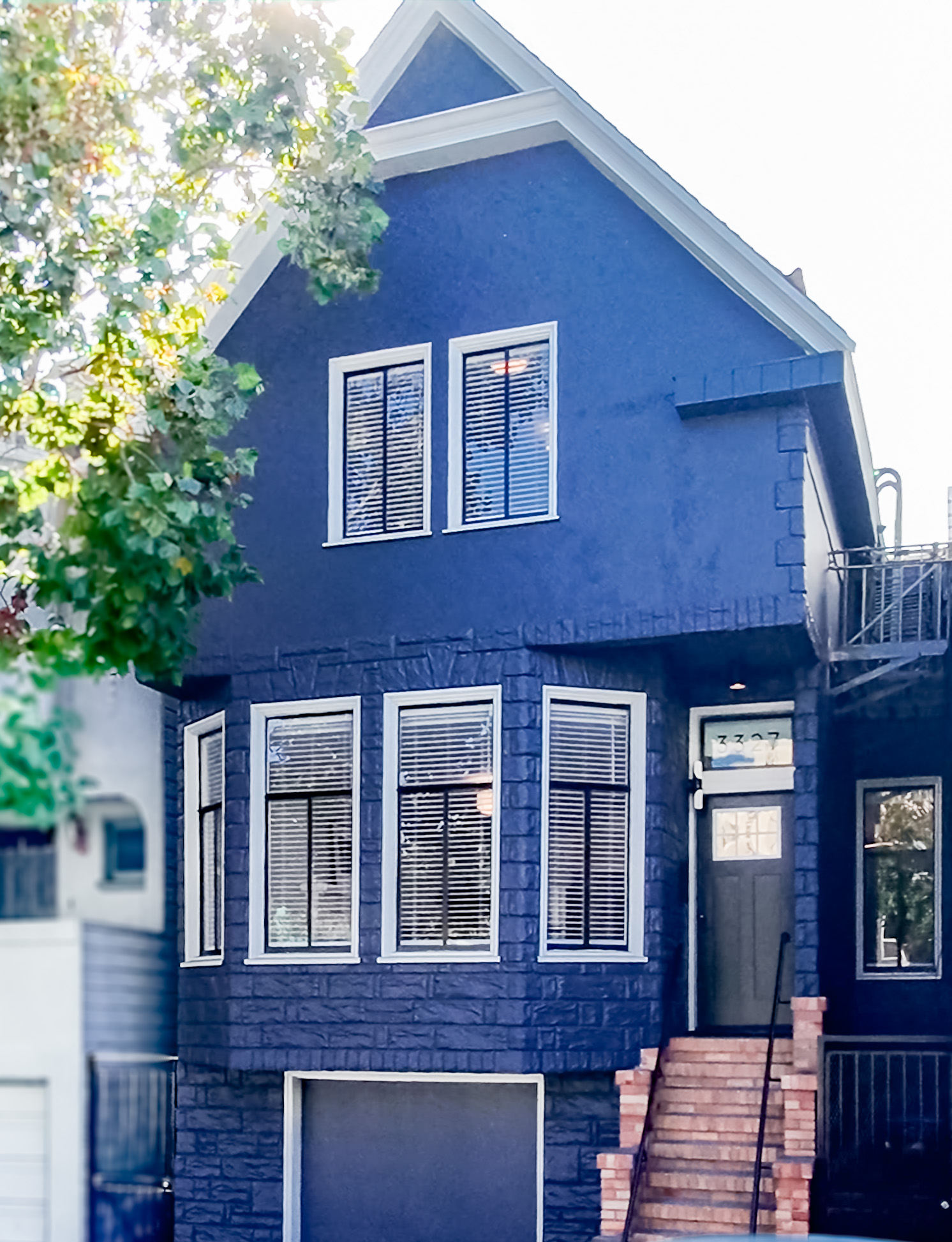 Cesar House exterior, a blue Victorian on Cesar Chavez